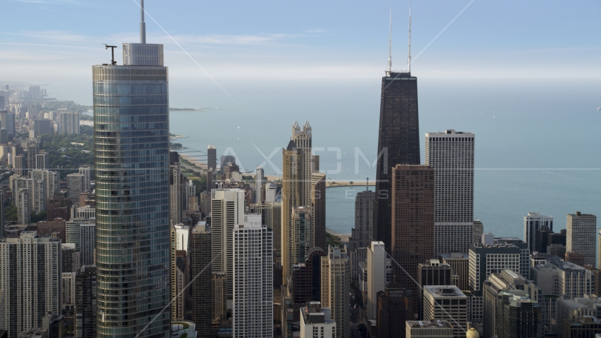 John Hancock Center behind Trump International Hotel and Tower in Downtown Chicago, Illinois Aerial Stock Photo AX0001_053.0000021F | Axiom Images