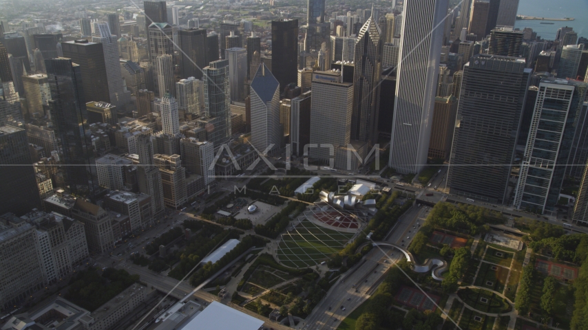 Cloud Gate sculpture and Jay Pritzker Pavilion in Grant Park, Downtown Chicago, Illinois Aerial Stock Photo AX0001_103.0000270F | Axiom Images