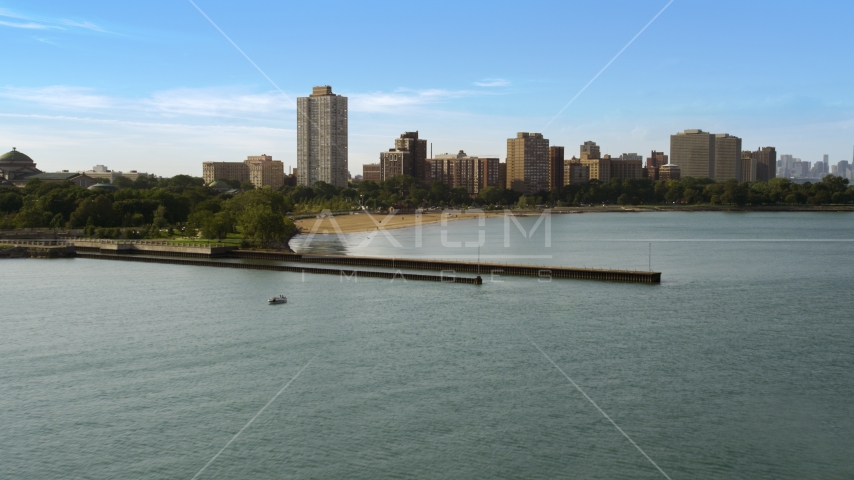 Piers on Lake Michigan near a beach and apartment buildings in Hyde Park, Chicago, Illinois Aerial Stock Photo AX0002_002.0000028F | Axiom Images