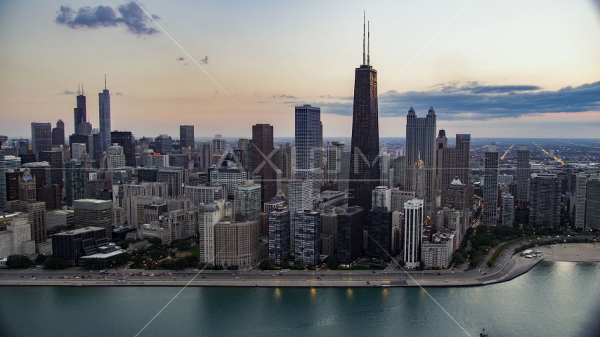 John Hancock Center and Downtown Chicago skyscrapers on a cloudy day at twilight, Illinois Aerial Stock Photo AX0003_069.0000258F | Axiom Images