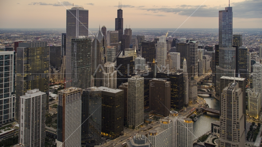 Skyscrapers and high-rises by Chicago River at twilight in Downtown Chicago, Illinois Aerial Stock Photo AX0003_079.0000288F | Axiom Images