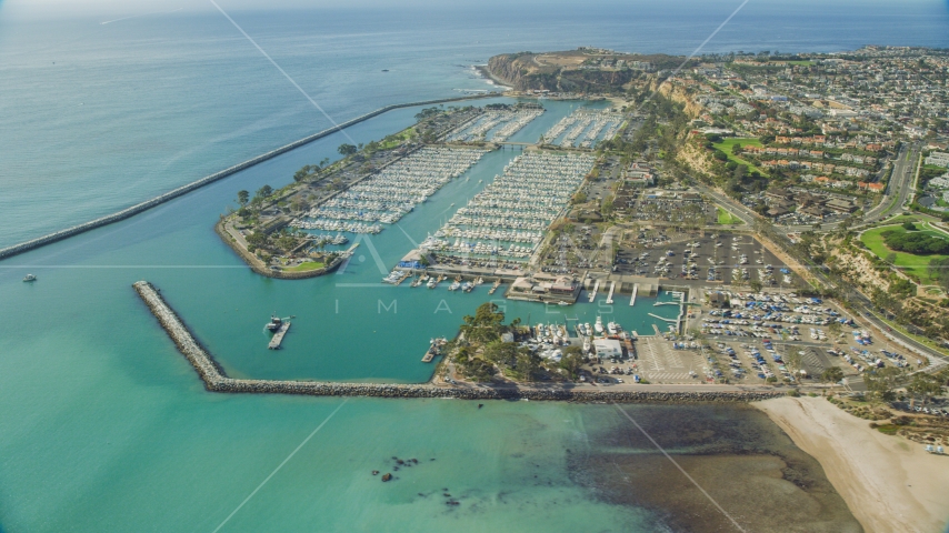 Breakwaters around Dana Point Harbor by seaside neighborhoods in Dana Point, California Aerial Stock Photo AX0159_188.0000000 | Axiom Images