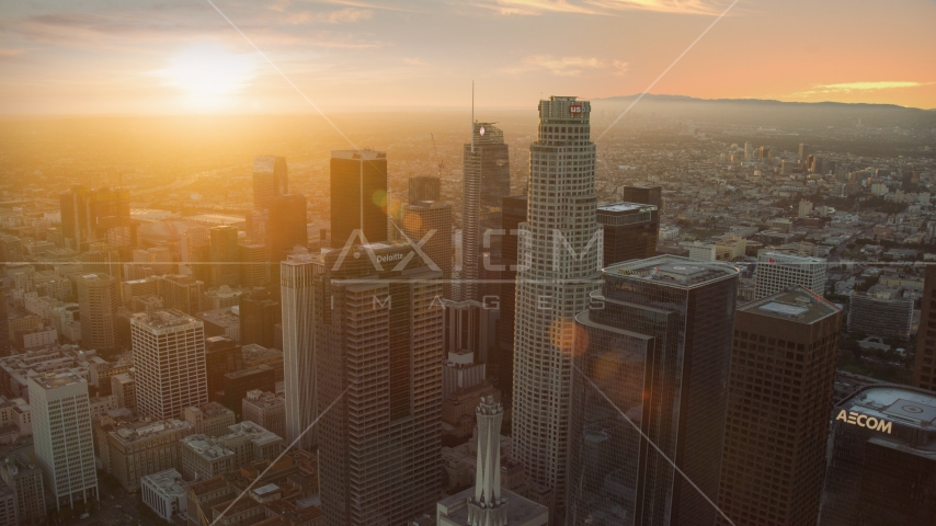 US Bank Tower and nearby skyscrapers at sunset in Downtown Los Angeles, California Aerial Stock Photo AX0162_083.0000312 | Axiom Images