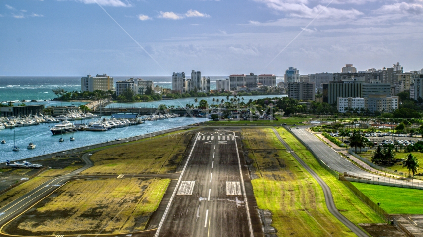 Waterfront hotels and apartment buildings seen from Isla Grande Airport, San Juan, Puerto Rico Aerial Stock Photo AX101_002.0000000F | Axiom Images