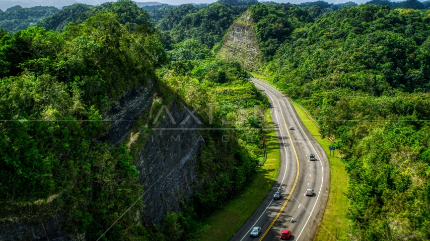 Light highway  traffic through lush green mountains, Karst Forest, Puerto Rico  Aerial Stock Photo AX101_078.0000299F | Axiom Images