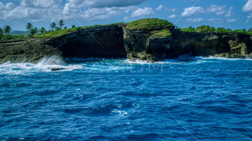 Rock formations on the rugged island coast and crystal blue water, Arecibo, Puerto Rico  Aerial Stock Photo AX101_165.0000040F | Axiom Images