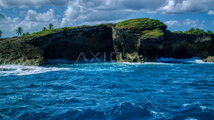 Rock formations on the rugged coast with crystal blue water, Arecibo, Puerto Rico  Aerial Stock Photo AX101_165.0000153F | Axiom Images