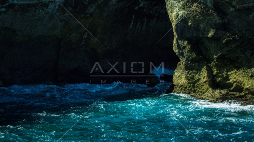 A coastal sea cave in rock formations in the Caribbean, Arecibo, Puerto Rico Aerial Stock Photo AX101_166.0000124F | Axiom Images