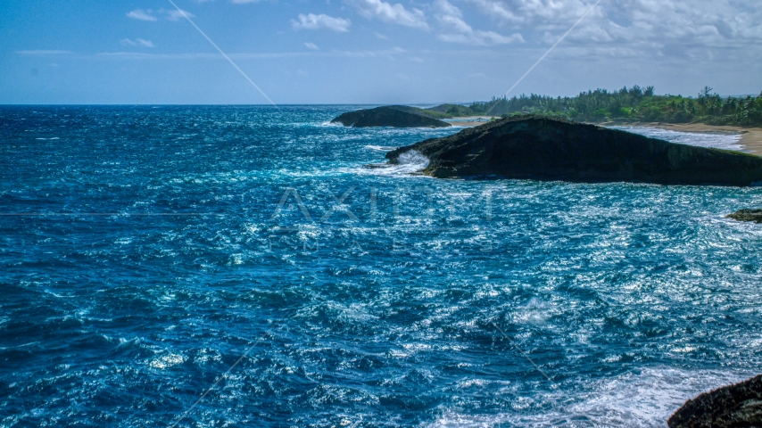 Domed rock formation in crystal blue waters, Arecibo, Puerto Rico Aerial Stock Photo AX101_169.0000312F | Axiom Images