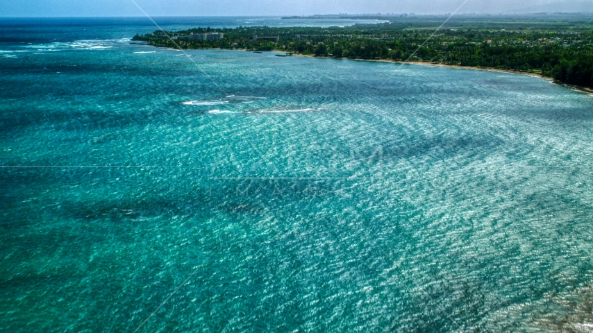 Private resort and beach across beautiful blue water of a bay, Dorado, Puerto Rico  Aerial Stock Photo AX101_215.0000300F | Axiom Images