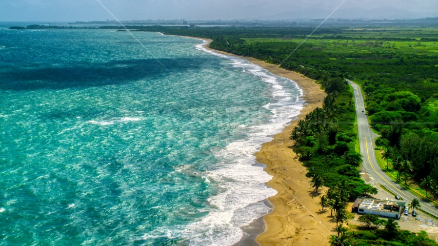 Beach and highway beside crystal blue waters, Dorado, Puerto Rico Aerial Stock Photo AX101_221.0000226F | Axiom Images