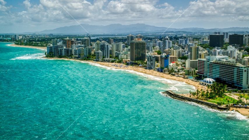 Beachside hotels and high-rises beside crystal blue waters, San Juan, Puerto Rico Aerial Stock Photo AX102_003.0000156F | Axiom Images