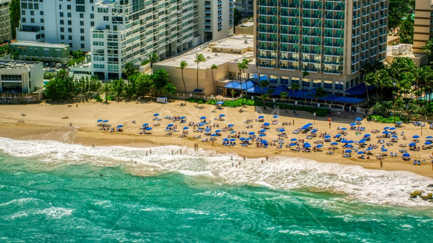 Tourists enjoying clear blue waters and the Caribbean beach, San Juan, Puerto Rico Aerial Stock Photo AX102_004.0000129F | Axiom Images