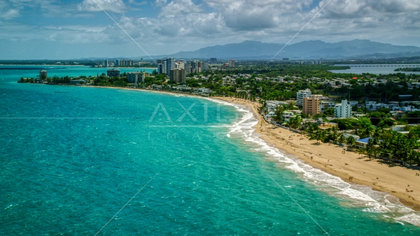 Beachside homes and apartment buildings beside crystal blue water, San Juan, Puerto Rico Aerial Stock Photo AX102_006.0000000F | Axiom Images