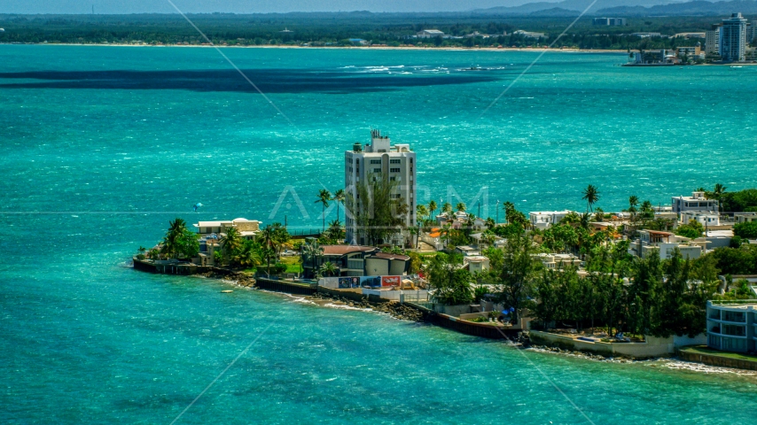 Oceanfront homes beside pristine blue water, San Juan, Puerto Rico Aerial Stock Photo AX102_007.0000000F | Axiom Images