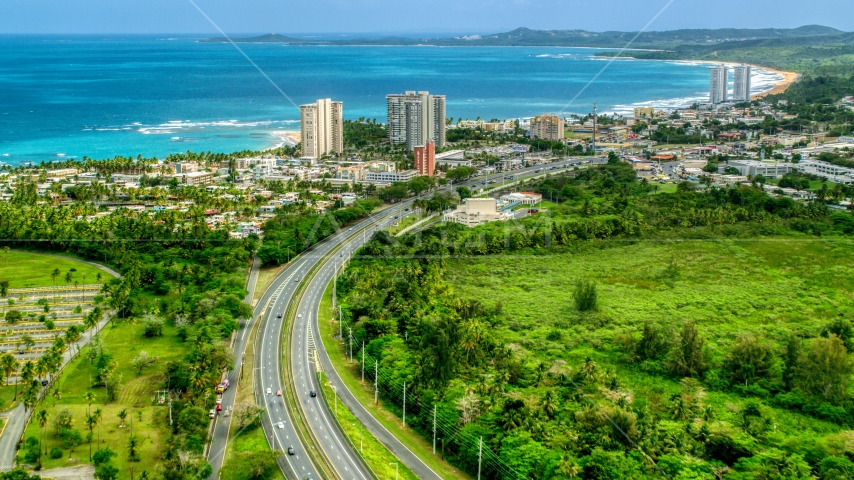 Beachside community and condos by crystal blue waters, Luquillo, Puerto Rico Aerial Stock Photo AX102_049.0000000F | Axiom Images