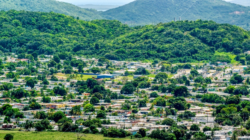 Homes at the base of tree covered hills, Fajardo, Puerto Rico  Aerial Stock Photo AX102_056.0000000F | Axiom Images