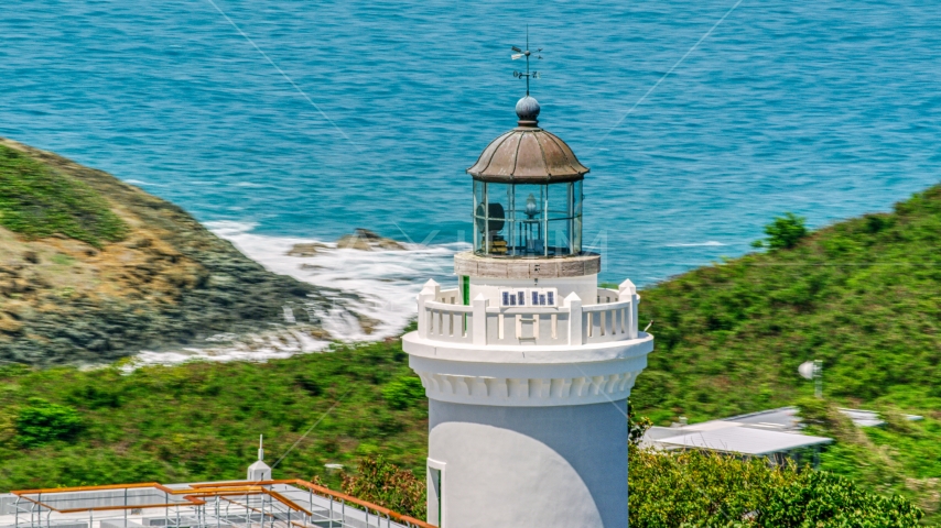 Cape San Juan Light tower in Fajardo, Puerto Rico, with ocean views Aerial Stock Photo AX102_068.0000169F | Axiom Images