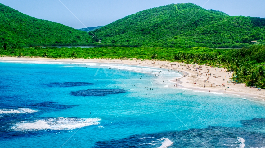 Beachgoers on a white sand Caribbean beach by sapphire blue waters, Culebra, Puerto Rico  Aerial Stock Photo AX102_112.0000000F | Axiom Images