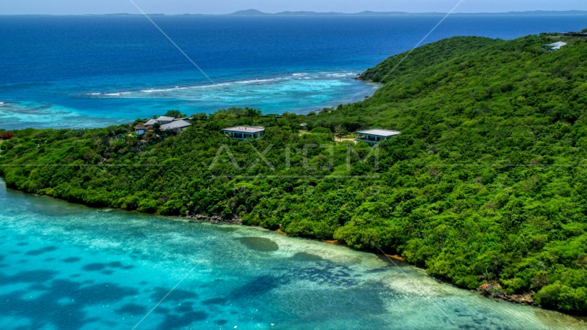 Oceanfront homes and trees overlooking sapphire blue waters, Culebra, Puerto Rico  Aerial Stock Photo AX102_137.0000000F | Axiom Images