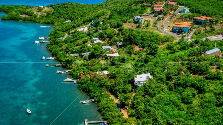 Oceanfront homes and docks along the coast and sapphire waters, Culebra, Puerto Rico Aerial Stock Photo AX102_157.0000125F | Axiom Images