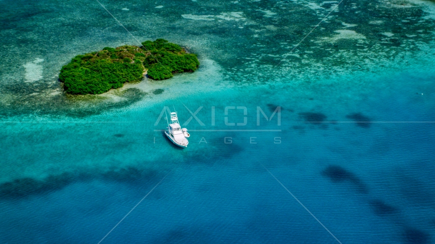 Fishing boat anchored near a reef and tiny Caribbean island, Culebra, Puerto Rico Aerial Stock Photo AX102_172.0000132F | Axiom Images