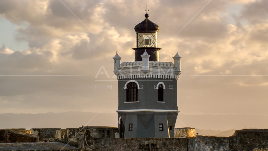 Port San Juan Light atop Fort San Felipe del Morro, Old San Juan, sunset Aerial Stock Photo AX104_027.0000110F | Axiom Images