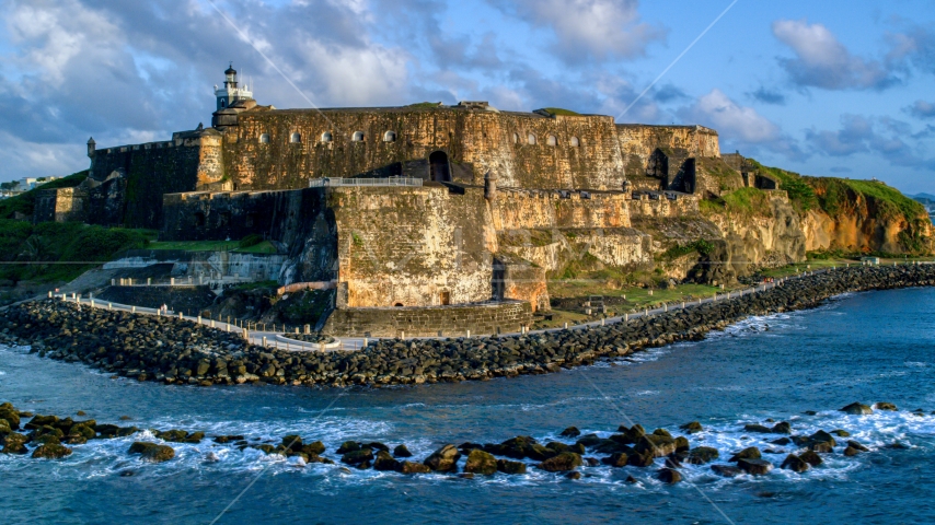 Fort San Felipe del Morro by calm ocean waters, Old San Juan, sunset Aerial Stock Photo AX104_030.0000011F | Axiom Images