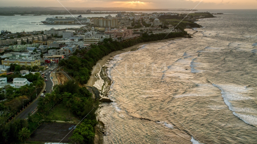 Caribbean buildings near the beach and ocean, Old San Juan, Puerto Rico, sunset Aerial Stock Photo AX104_075.0000083F | Axiom Images