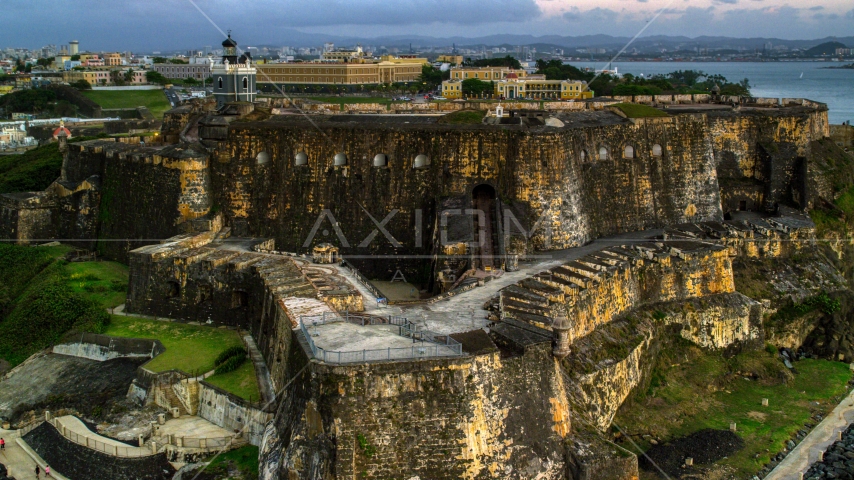 A view of Fort San Felipe del Morro, Old San Juan, Puerto Rico, twilight Aerial Stock Photo AX104_083.0000000F | Axiom Images