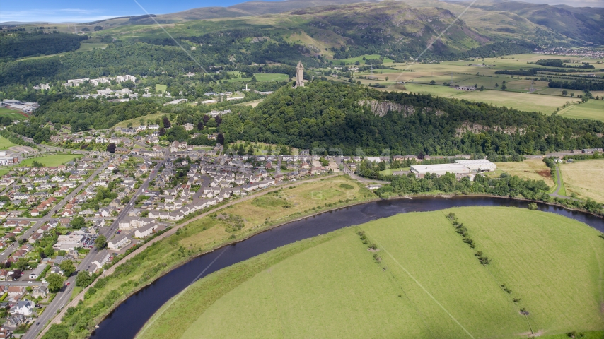 A view of the iconic Wallace Monument surrounded by trees, Stirling, Scotland Aerial Stock Photo AX109_046.0000000F | Axiom Images