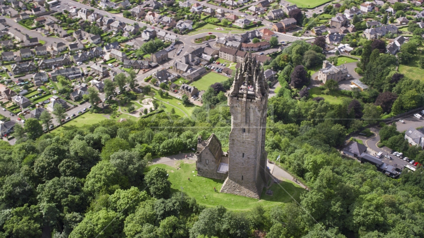 The historic Wallace Monument with tourists on top of the tower, Stirling, Scotland Aerial Stock Photo AX109_051.0000000F | Axiom Images