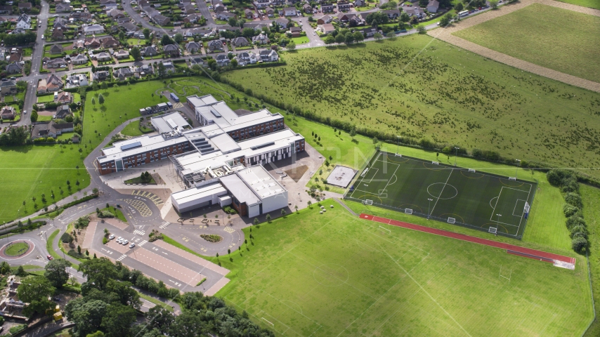 A view of Wallace High School and soccer field, Stirling, Scotland Aerial Stock Photo AX109_055.0000000F | Axiom Images