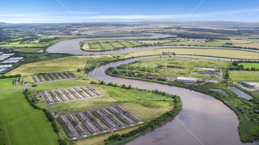 Riverfront warehouses by River Forth in Fallin, Scotland Aerial Stock Photo AX109_103.0000130F | Axiom Images