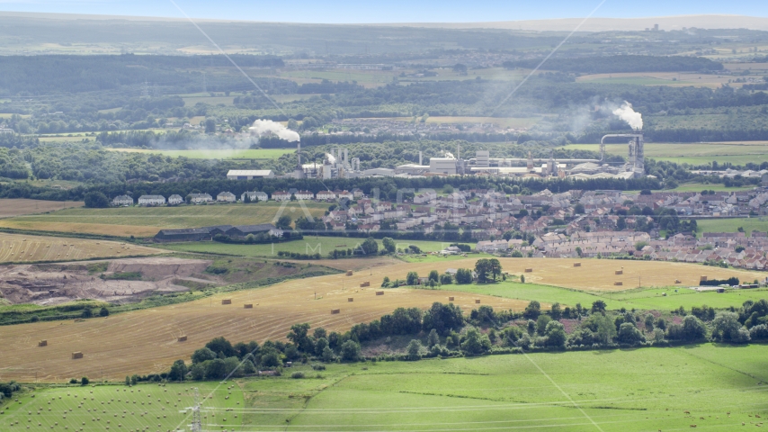 Factory and smoke stacks in a small town, Cowie, Scotland Aerial Stock Photo AX109_107.0000000F | Axiom Images