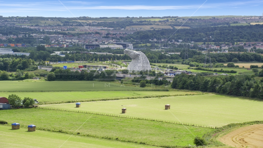 The Kelpies sculptures from seen from fields, Falkirk, Scotland Aerial Stock Photo AX109_120.0000000F | Axiom Images