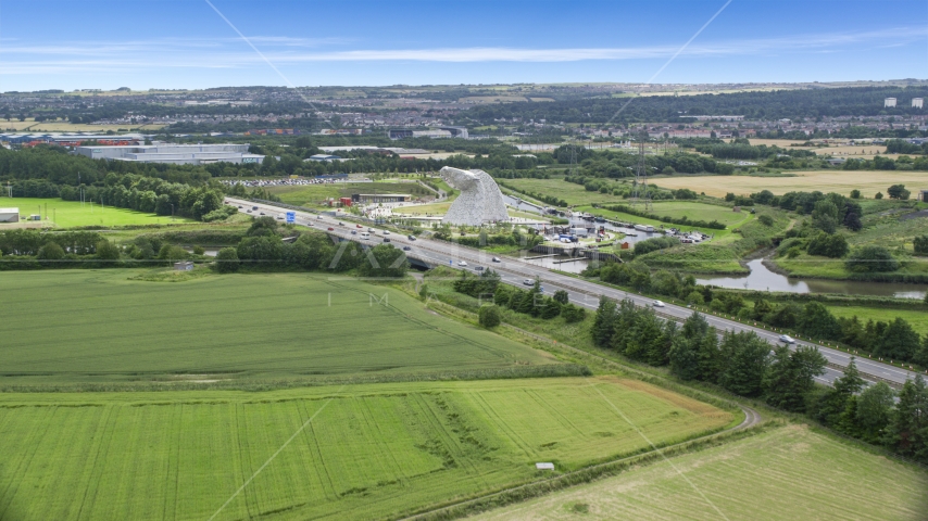 The Kelpies sculptures beside the M9 highway, Falkirk, Scotland Aerial Stock Photo AX109_122.0000073F | Axiom Images