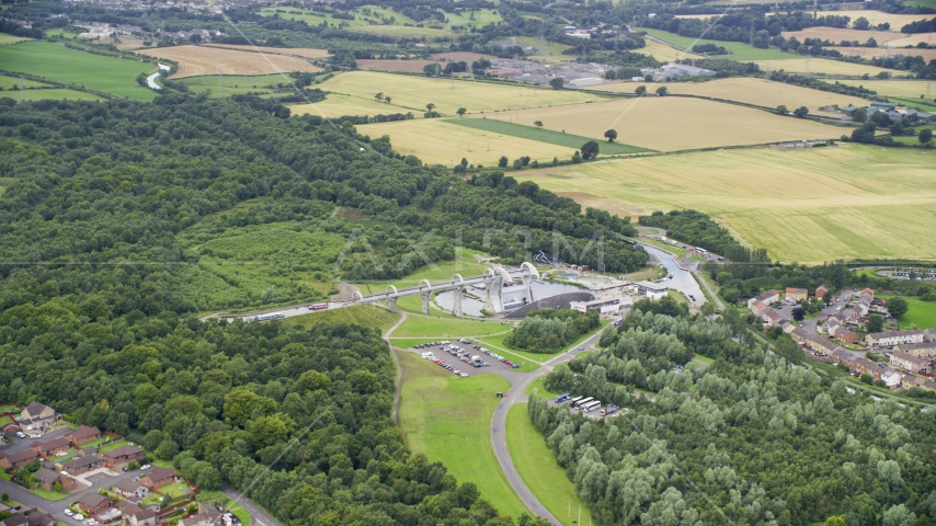 The iconic Falkirk Wheel boat lift near trees and farmland, Scotland Aerial Stock Photo AX109_161.0000000F | Axiom Images