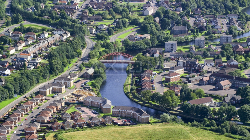 Small bridge on River Leven through residential neighborhood, Alexandria, Scotland Aerial Stock Photo AX110_133.0000150F | Axiom Images