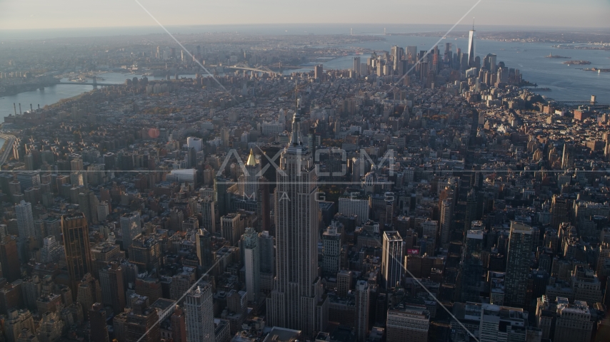 Empire State Building, the East River, and Lower Manhattan at sunrise in New York City Aerial Stock Photo AX118_203.0000000F | Axiom Images