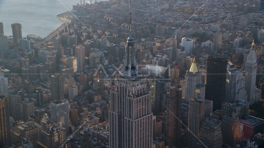 The spire on top of the Empire State Building at sunrise in Midtown Manhattan, New York City Aerial Stock Photo AX118_204.0000082F | Axiom Images