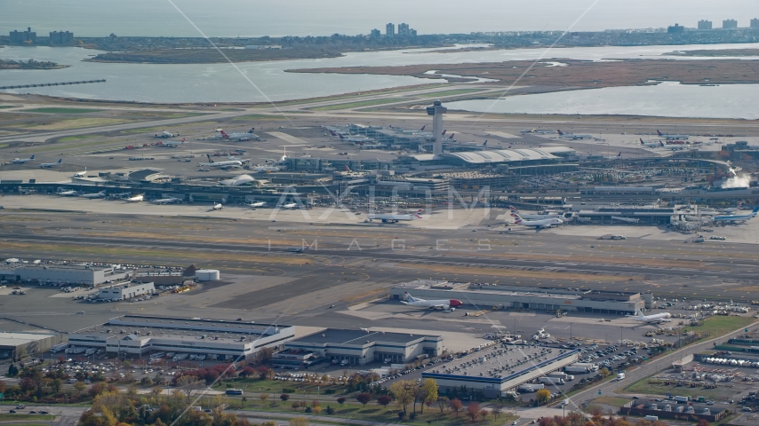 Control tower and terminals of John F. Kennedy International Airport in Autumn, Queens, New York City Aerial Stock Photo AX120_049.0000064F | Axiom Images