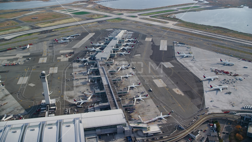 Rows of airliners at terminals at John F Kennedy International Airport, New York City Aerial Stock Photo AX120_065.0000258F | Axiom Images