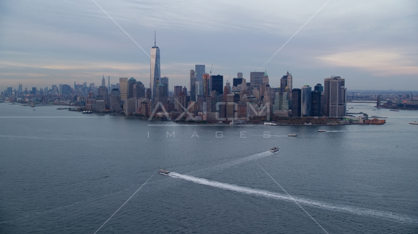 The Lower Manhattan skyline at sunset in Autumn, New York City, seen from New York Harbor Aerial Stock Photo AX121_016.0000107F | Axiom Images