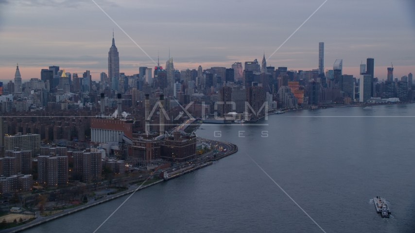 East Village power plant and Midtown skyscrapers at sunset in New York City Aerial Stock Photo AX121_046.0000078F | Axiom Images