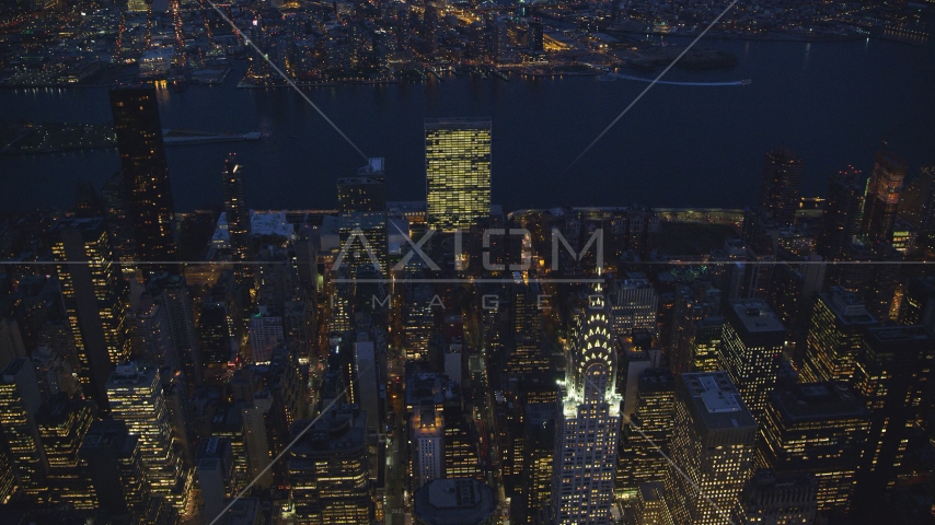 The United Nations and top of the Chrysler Building at night in New York City Aerial Stock Photo AX121_138.0000000F | Axiom Images