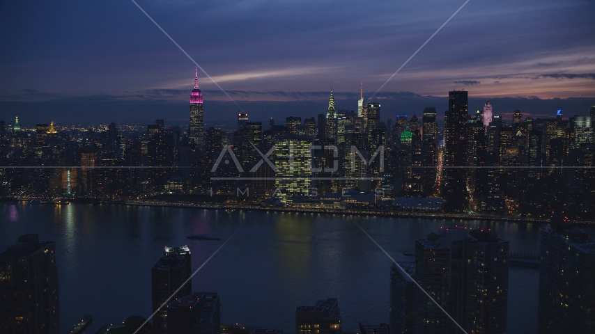 Midtown Manhattan across the East River at night in New York City Aerial Stock Photo AX121_144.0000032F | Axiom Images