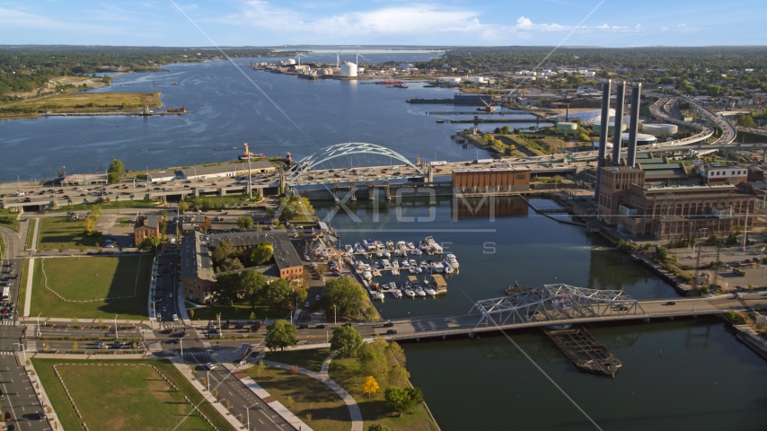 A view of the Providence River Bridge by a power plant with smoke stacks, Providence, Rhode Island Aerial Stock Photo AX145_069.0000206 | Axiom Images