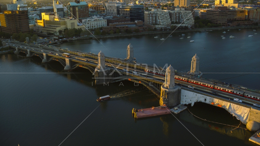 A commuter train on Longfellow Bridge in Boston, Massachusetts, sunset Aerial Stock Photo AX146_068.0000149F | Axiom Images