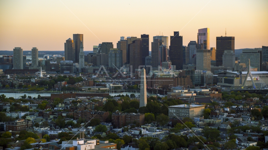 The Bunker Hill Monument at sunset in Charlestown, Massachusetts, and the Downtown Boston skyline Aerial Stock Photo AX146_091.0000324F | Axiom Images